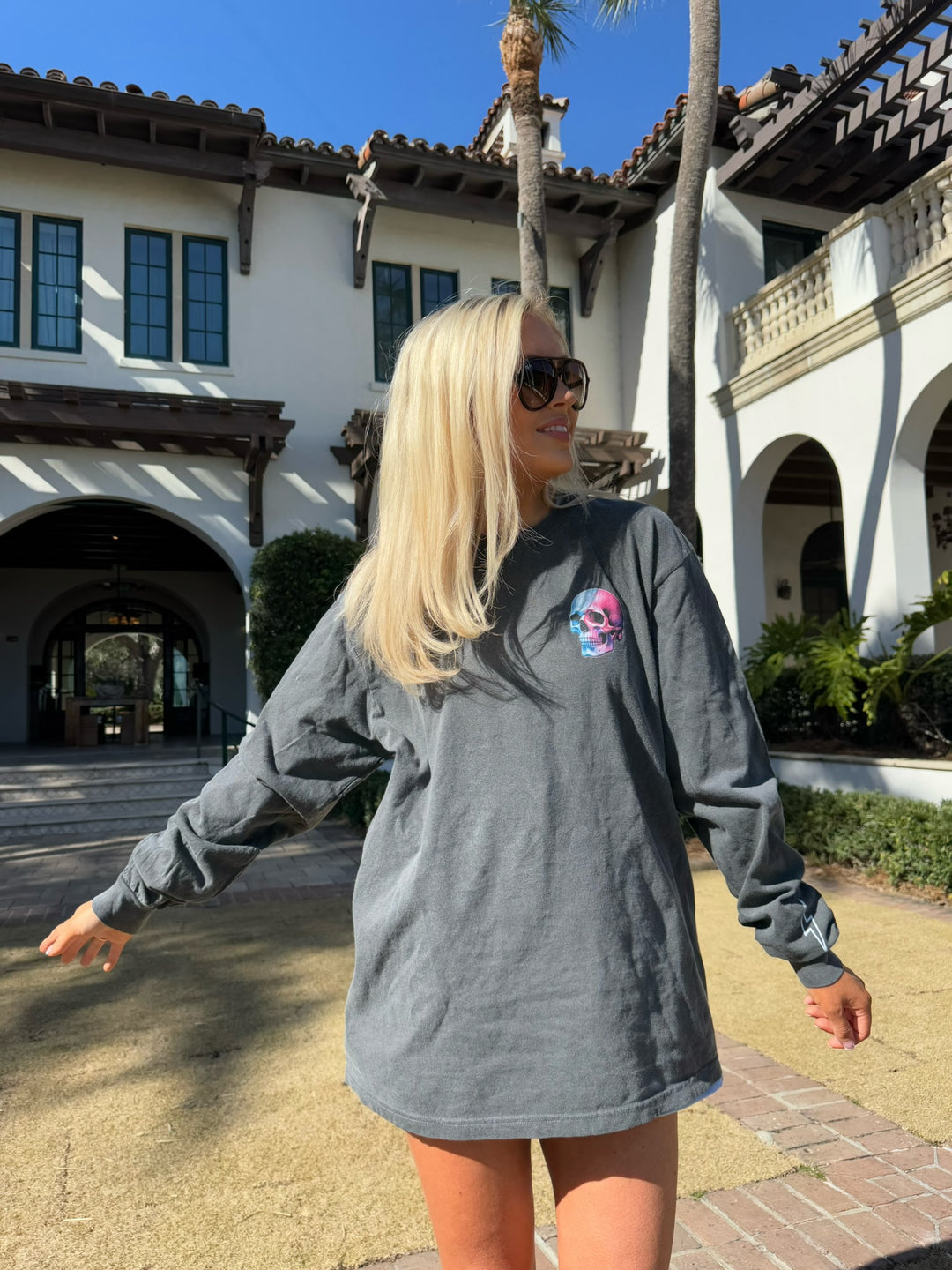 Model wearing Skull Powers Long Sleeve Tee Shirt - Dark Gray with Skull and Lightning Bolt Design