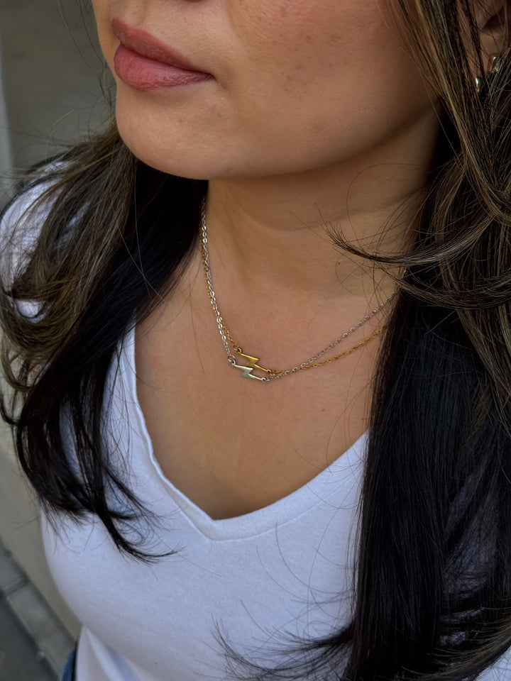 Model wearing Ladyspinedoc Lightning Bolt Necklaces in Gold and Silver