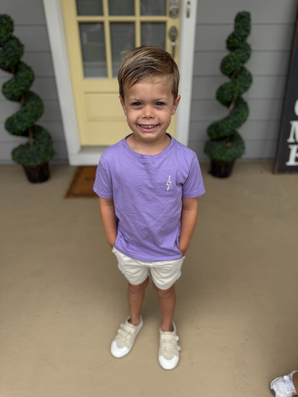 Child wearing The Incredible Toddler Tee - Kids Violet T-Shirt, showing Ladyspinedoc lightning bolt on the front upper left chest