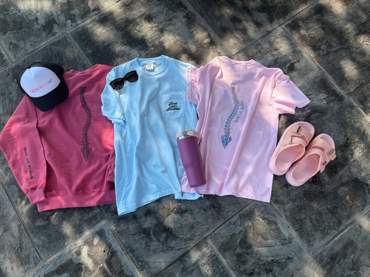 Flat lays of the three scoliosis awareness shirts in the Ladyspinedoc collection, two t-shirts and one sweatshirt.