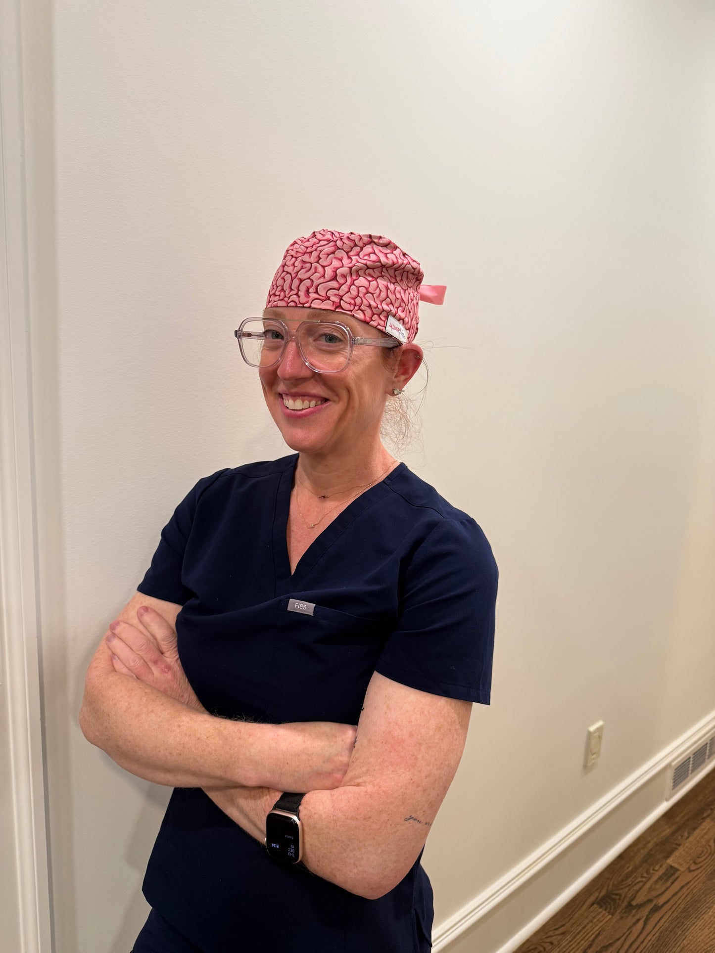 Dr. Betsy Grunch (Ladyspinedoc) wearing her pink Cortex Scrub Hat with brain design
