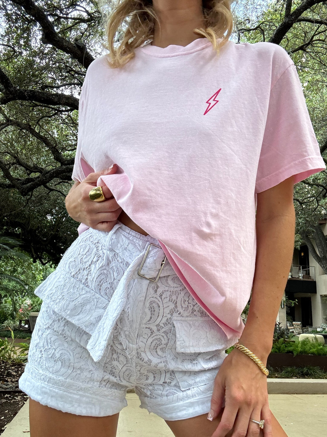 Close-up of the light pink Big Brain Energy tee styled with white lace shorts.