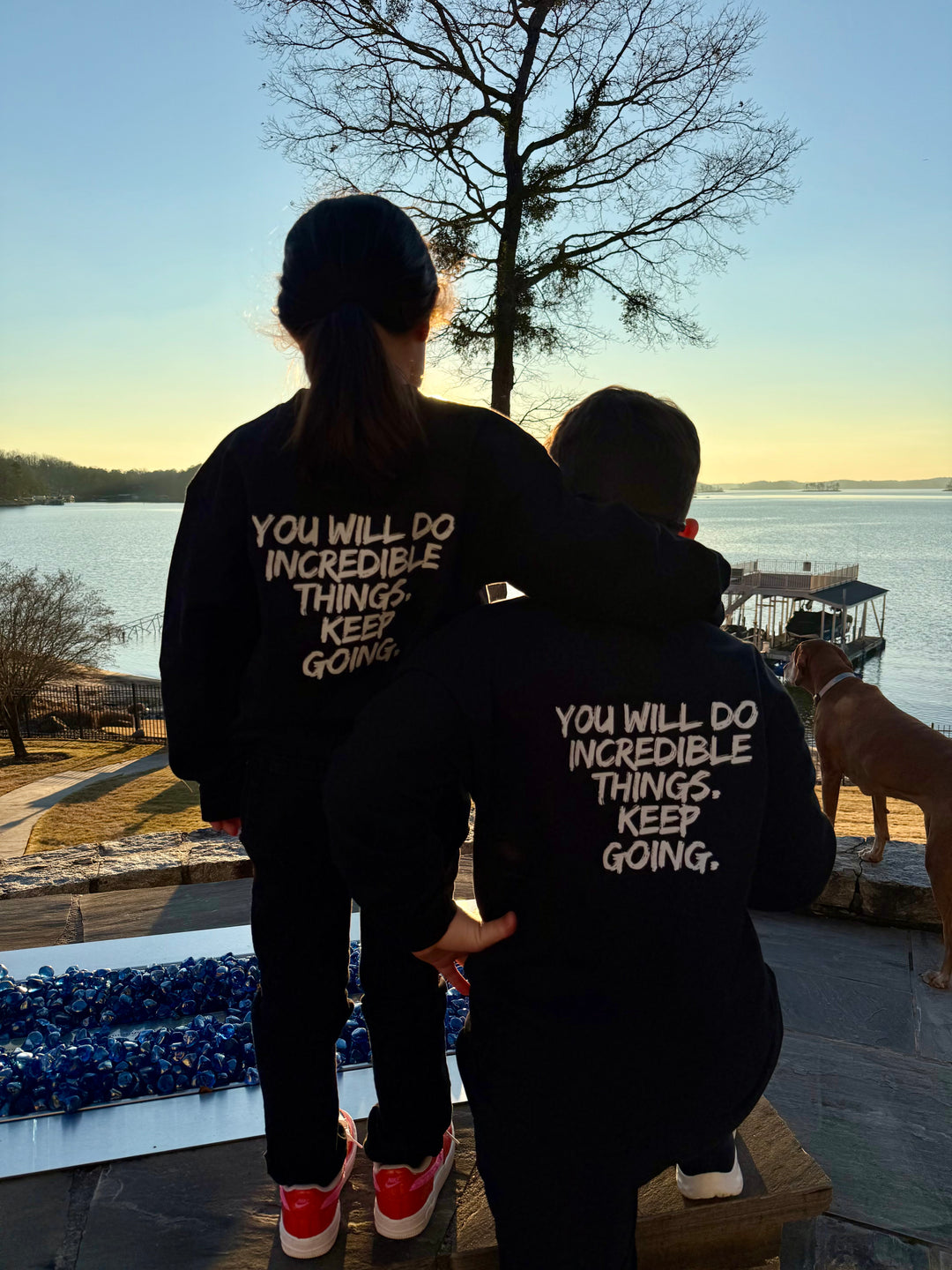 Two youth models wearing the Incredible Youth Crewneck Sweatshirts, facing away and showing the back design with bold white brushstroke message: "YOU WILL DO INCREDIBLE THINGS. KEEP GOING."
