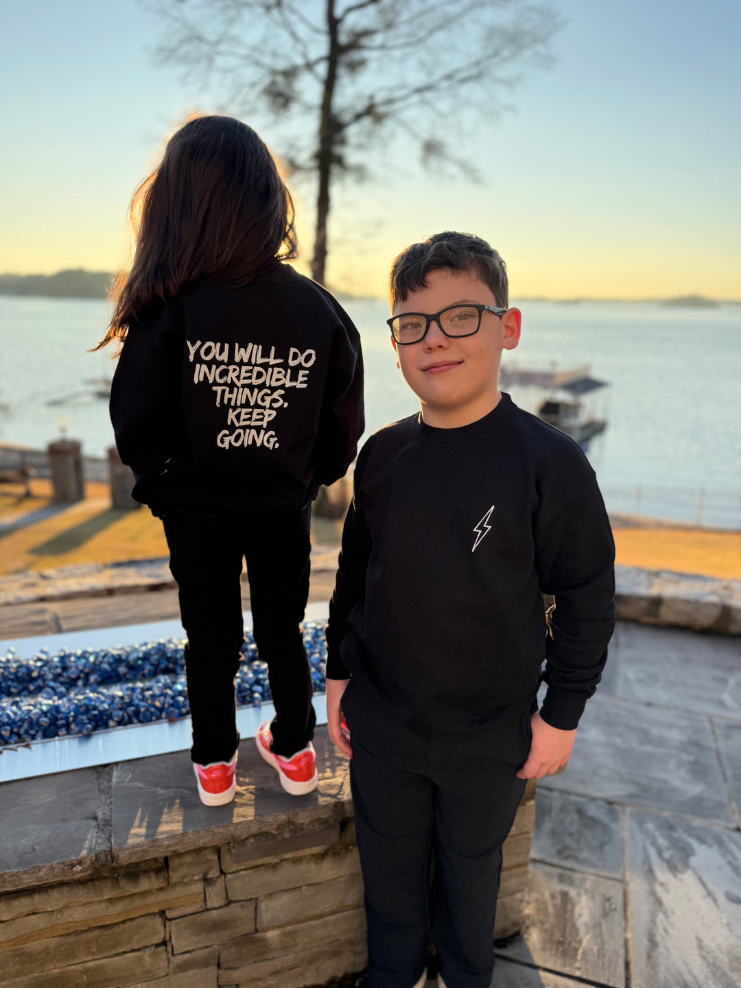 Boy facing front and girl facing back showing off the front and back views of the Incredible Youth Crewneck Sweatshirts.