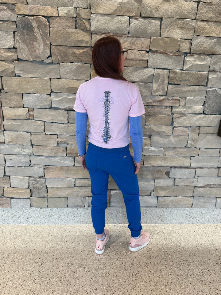 Full view of Dr. Betsy Grunch (Ladyspinedoc) wearing and showing off the back spine design of the light pink lumbar puncture tee shirt.