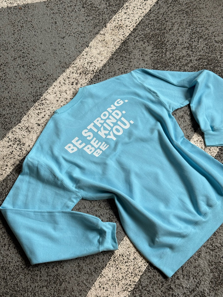 Back flat lay of BE YOU Crewneck Sweatshirt in light blue, showing the Be Strong. Be Kind. Be You. motivational motto.