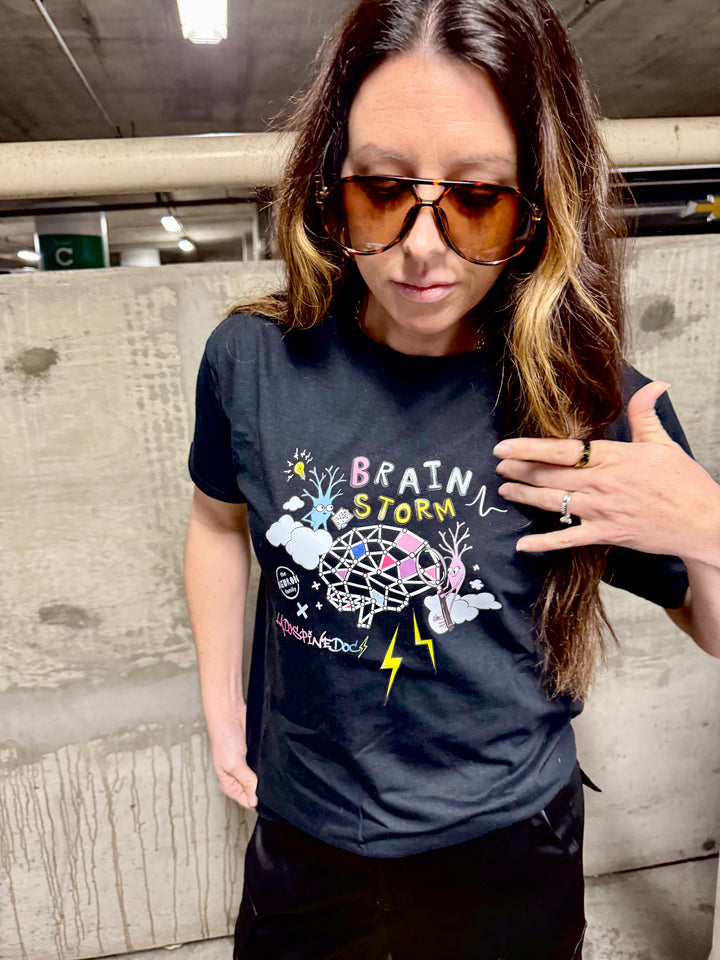 Model wearing the Ladyspinedoc x The Neuron Family brain storm / brainstorm tee shirt in black.