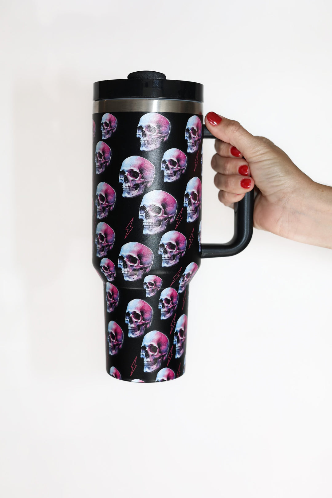 Black insulated cup with colorful skulls and pink lightning bolts.