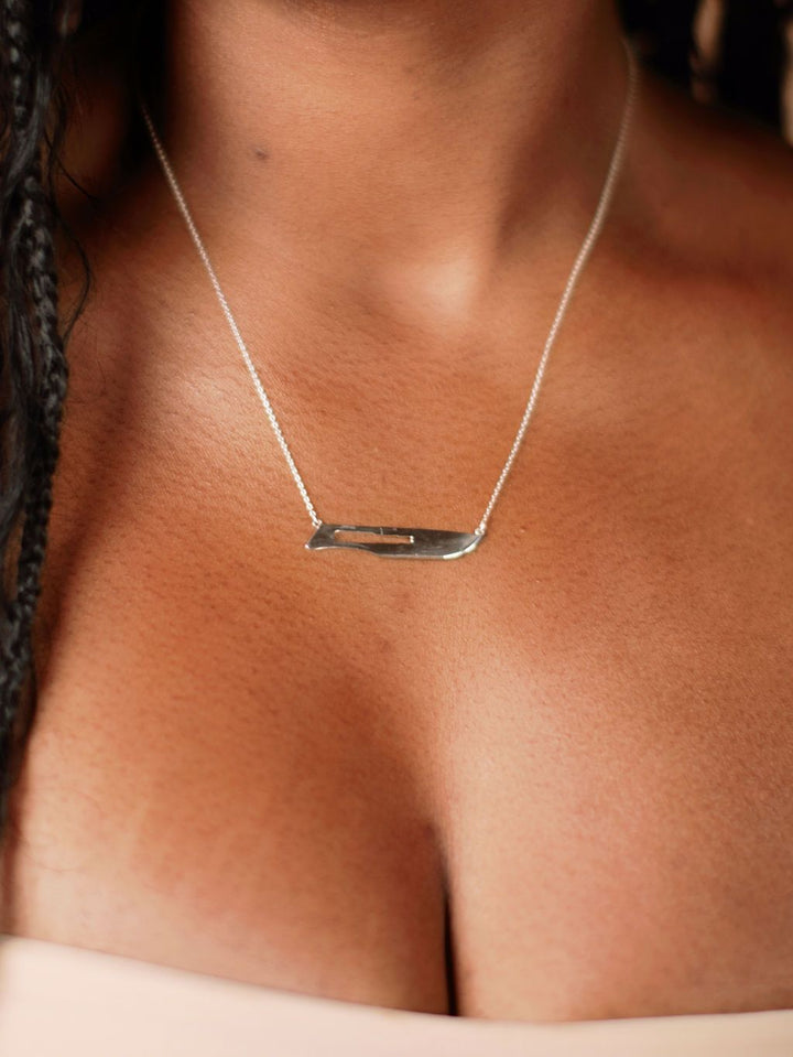 Model wearing silver 10 Blade Scalpel Pendant Necklace