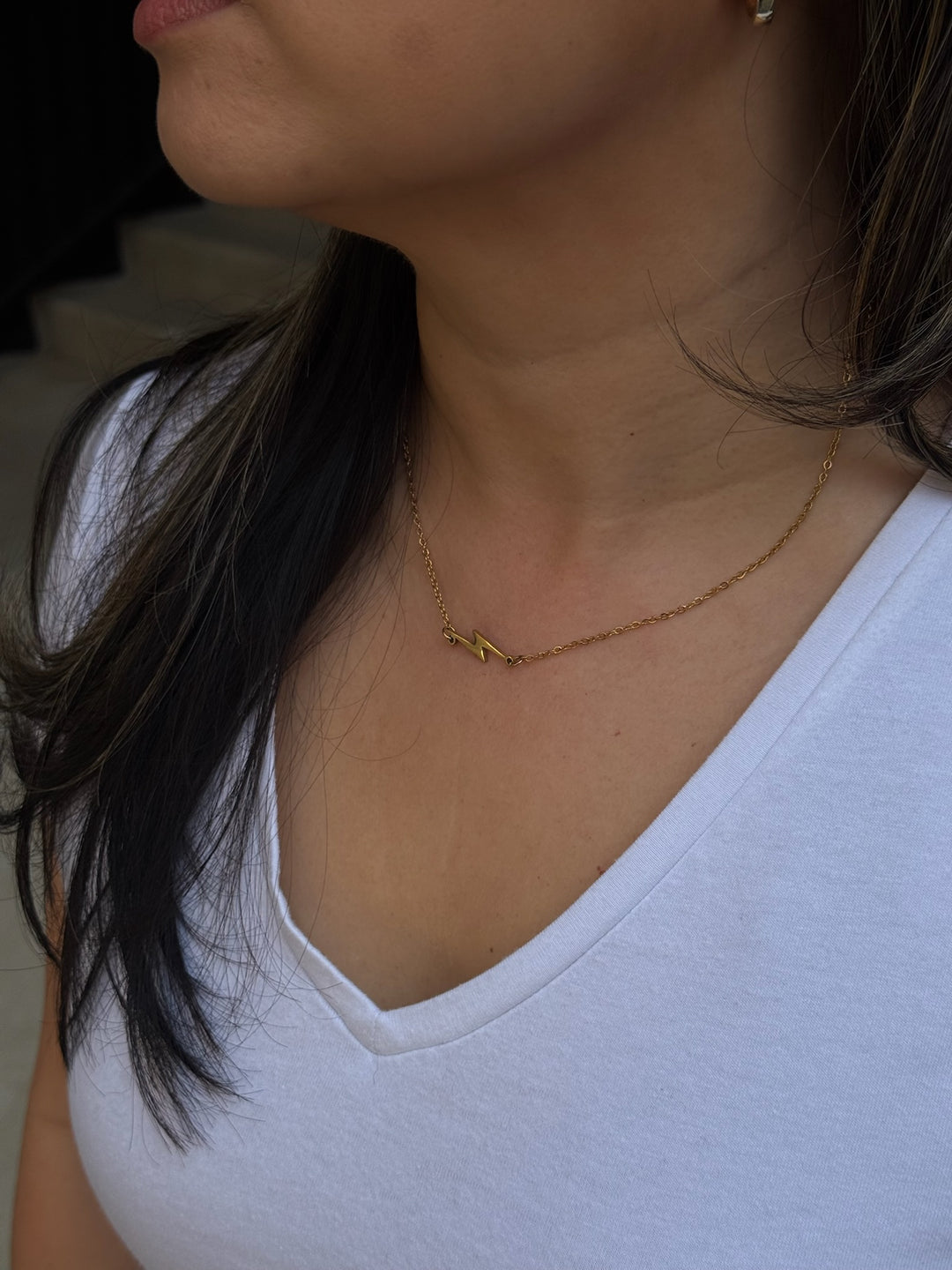 Model wearing Ladyspinedoc Lightning Bolt Necklace in Gold