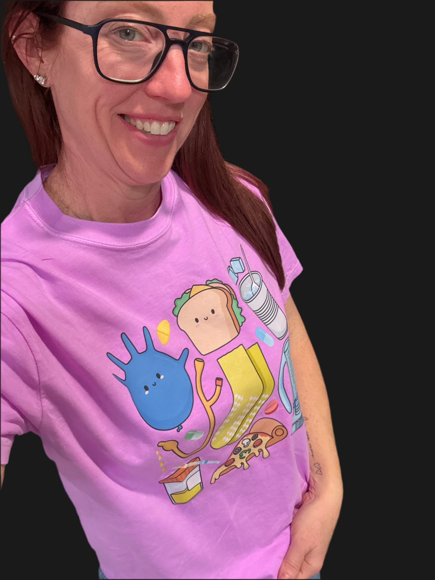 A smiling Dr. Betsy Grunch (Ladyspinedoc) wearing the Scrubhacks Collab: Nurses Week Tee Shirt - Purple Short Sleeve.