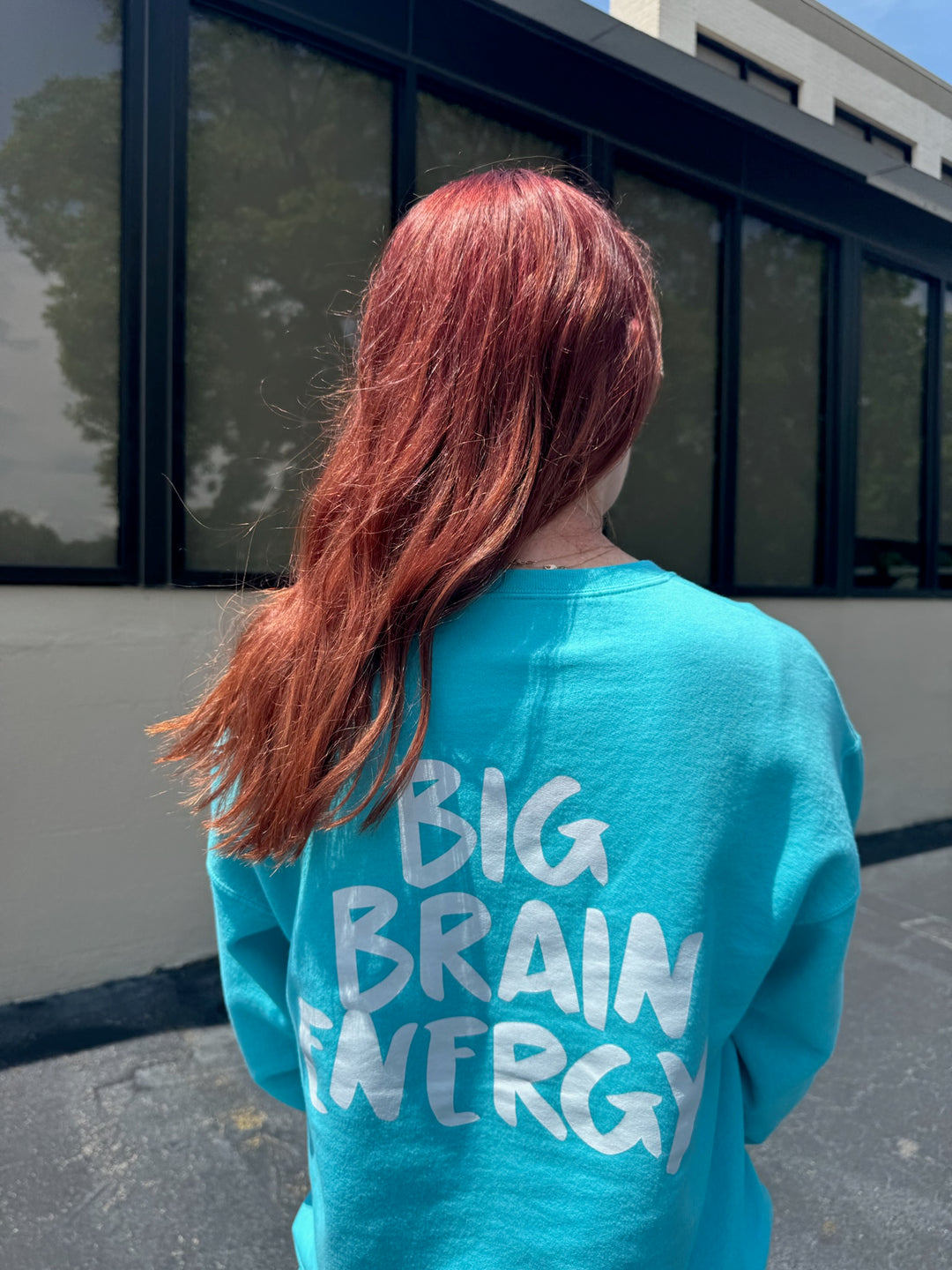 Back of Ladyspinedoc wearing the Big Brain Energy Crewneck Sweatshirt – Seafoam showing the "BIG BRAIN ENERGY" catchphrase on the back