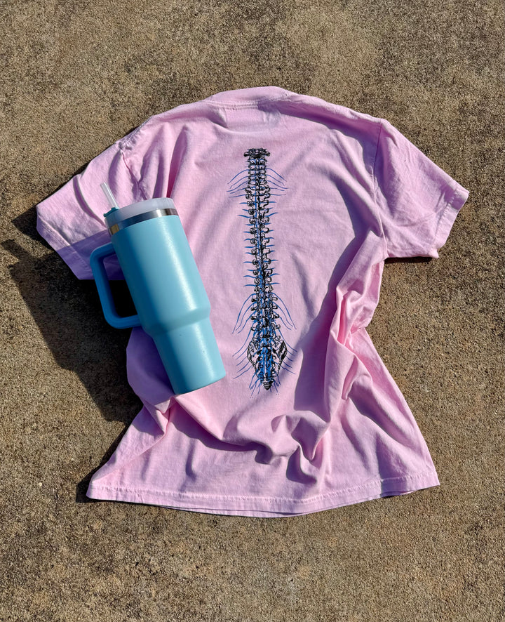Flat lay of the light pink lumbar puncture tee shirt showing the back spine design.