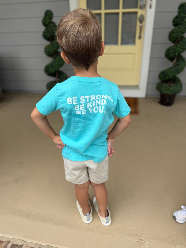 Back of child wearing the Be You Toddler Tee - Kids Caribbean Blue T-Shirt and showing off the  Motivational “BE STRONG. BE KIND. BE YOU.” Motto