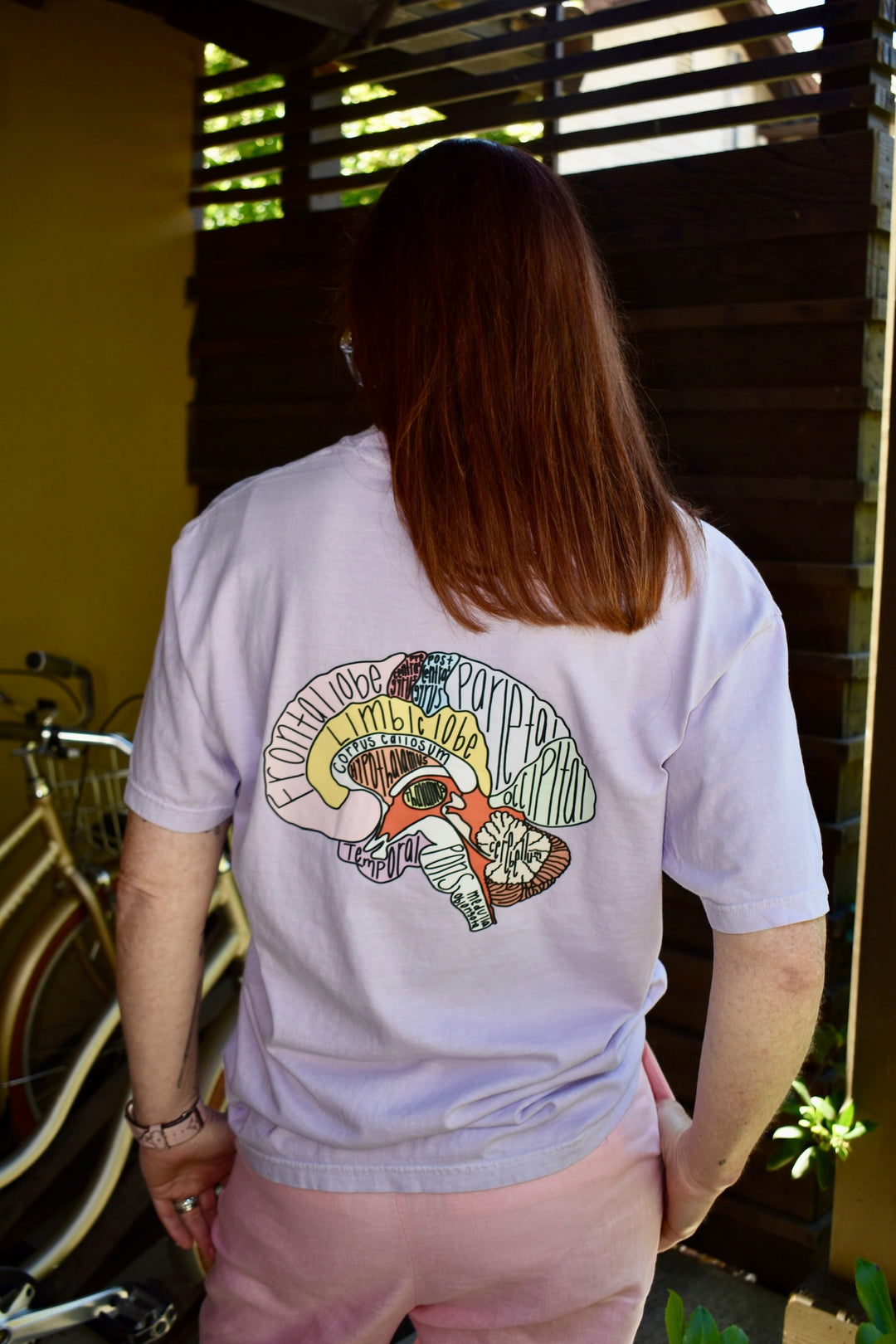 Ladyspinedoc showing off the design on the back of the I Lobe You Brain Anatomy Tee.