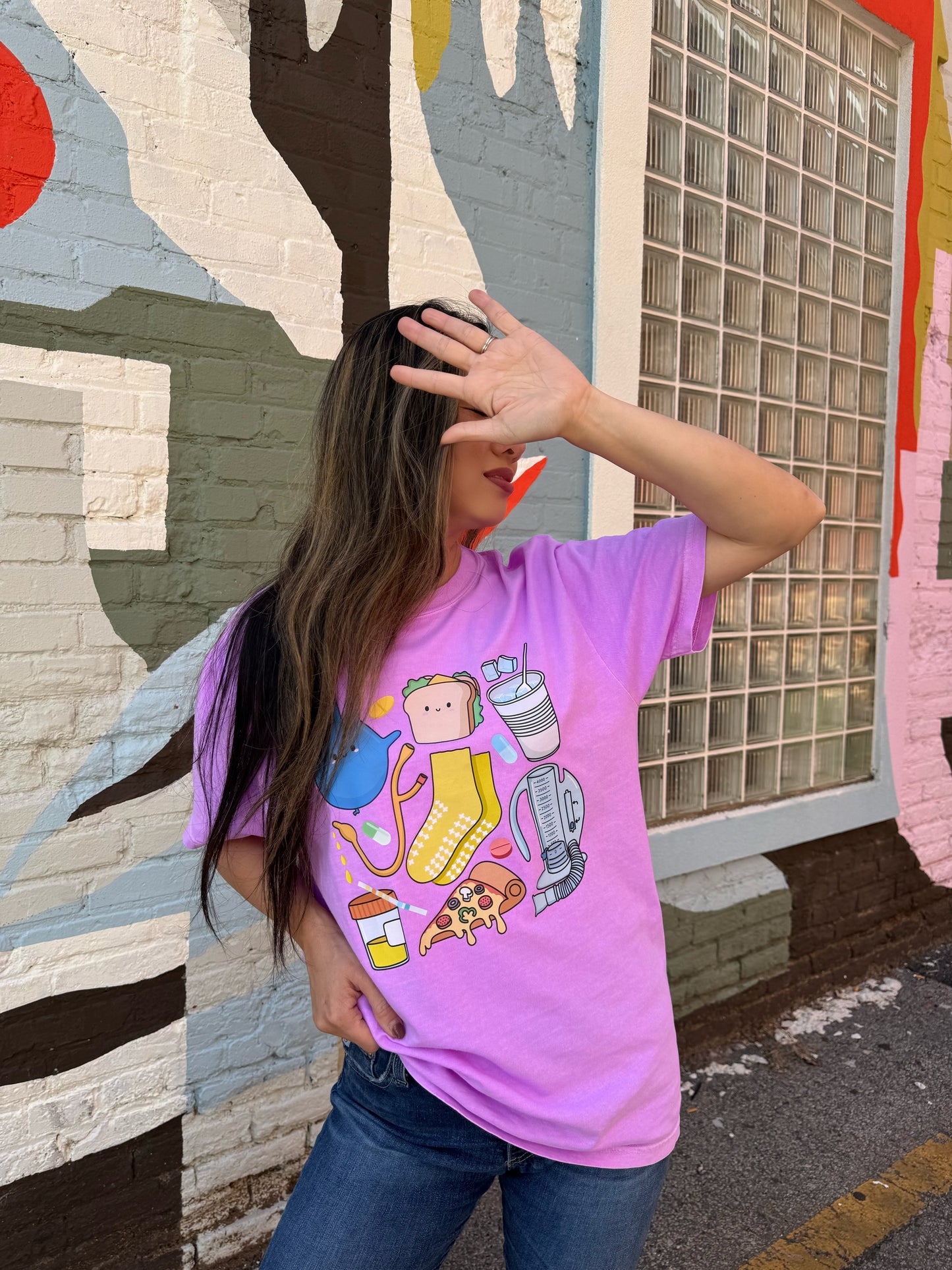 Woman holding her hand up and wearing the Scrubhacks Collab Nurses Week Tee Shirt - Purple Short Sleeve