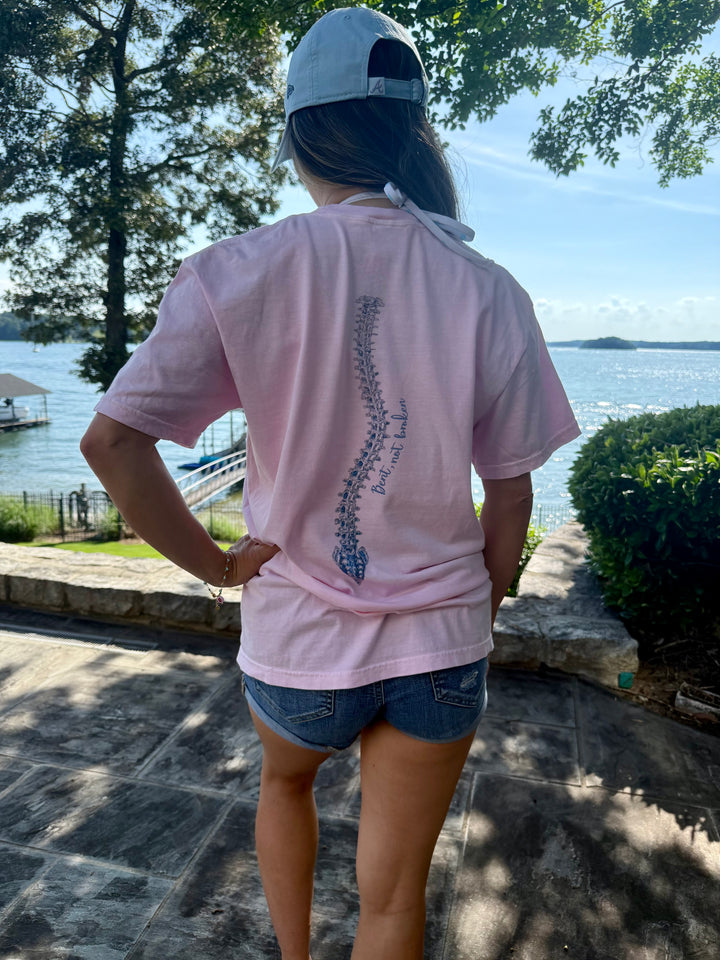 Model showing off the back spine design of the Bent, Not Broken Scoliosis Awareness Tee - Pink Cotton T-Shirt Short Sleeve