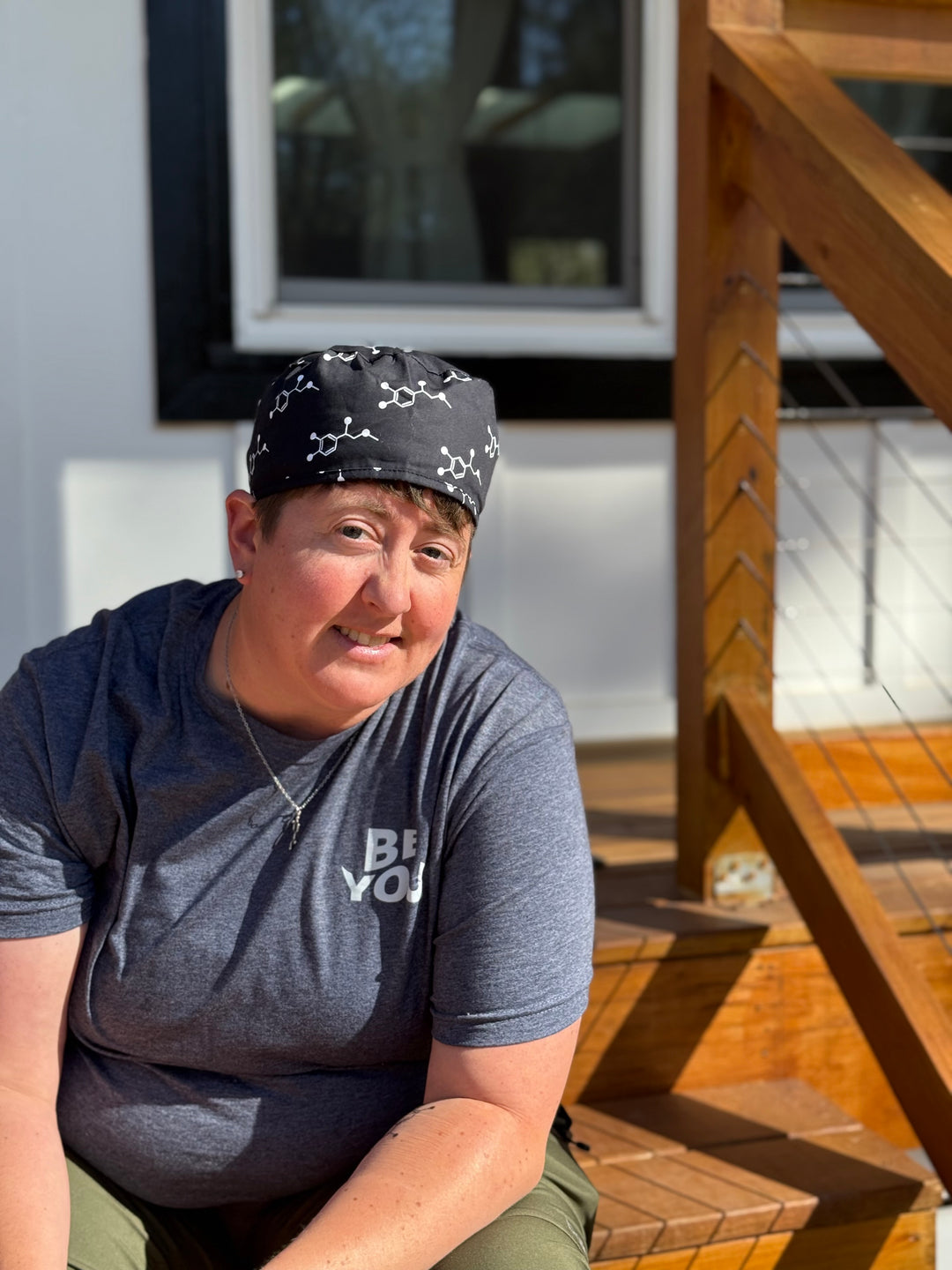 Front view of Dr. Beachgem wearing the Ladyspinedoc x Dr. Beachgem Code Cart Cap - Black Scrub Hat with White Epinephrine (Adrenaline) Molecule Design