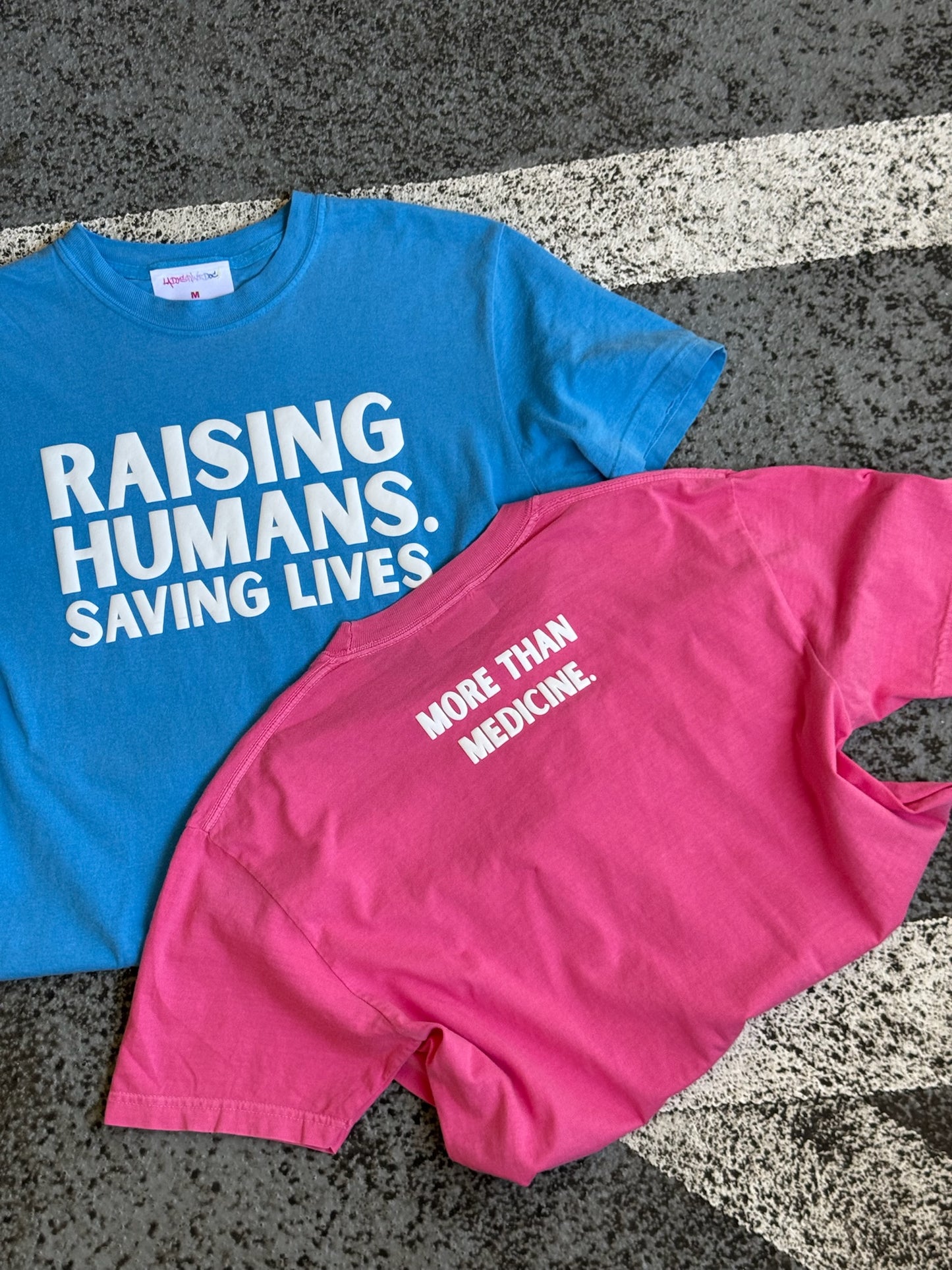 RAISING HUMANS. SAVING LIVES. Mama Tee Shirt - Pink or Blue