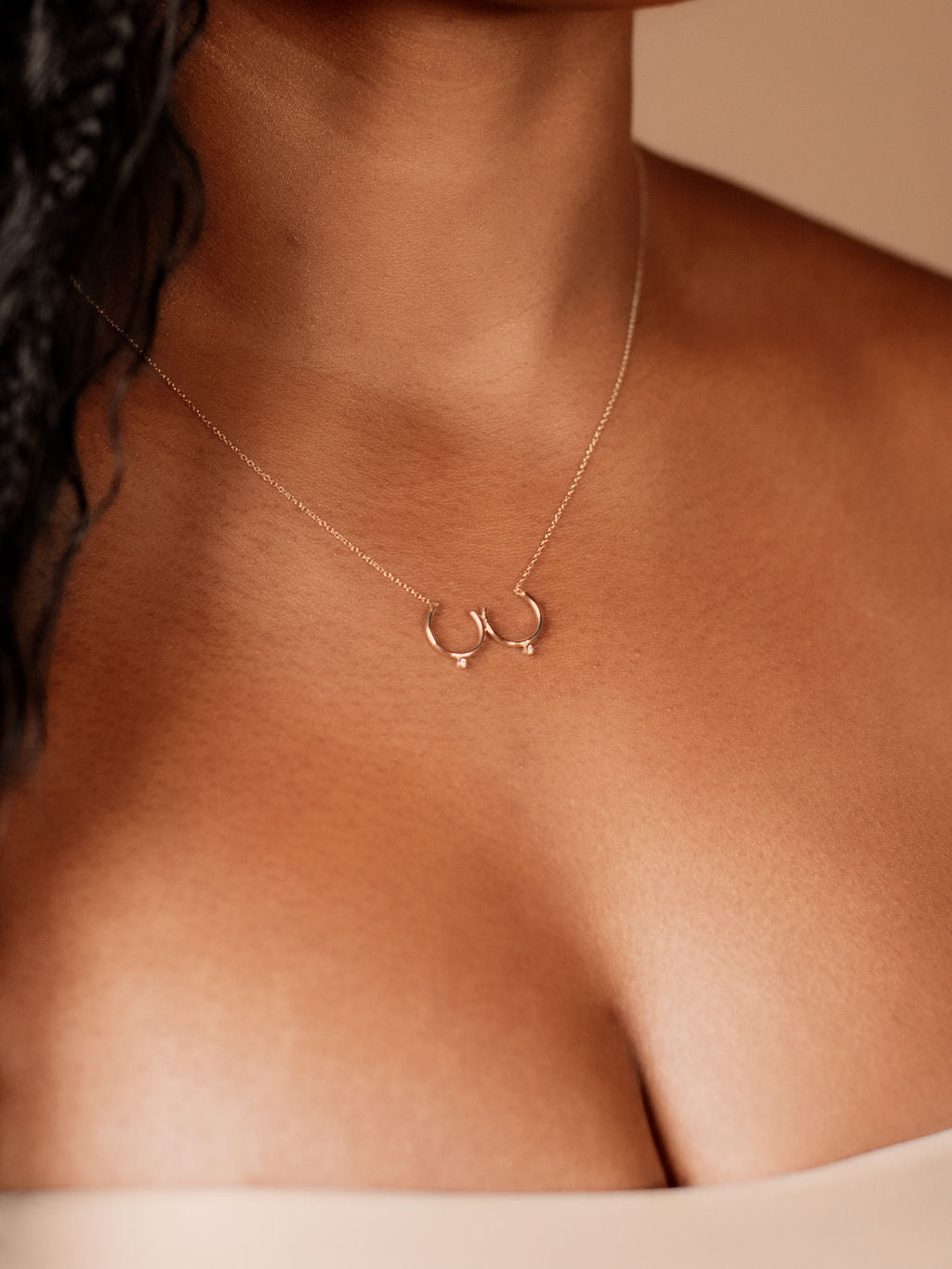 Model wearing gold Bust Necklace with Diamond Nipples