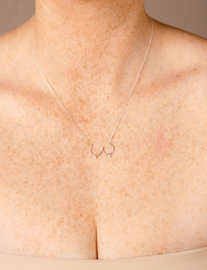 Model wearing silver Bust Necklace with Diamond Nipples