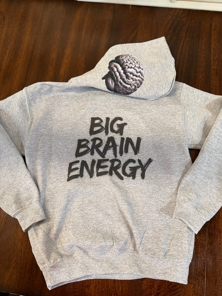 Light gray hoodie with "BIG BRAIN ENERGY" in bold black capital letters on the back and showcasing the brain design printed on the left side of the hood.