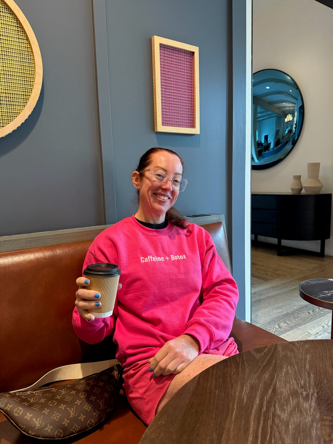 Ladyspinedoc holding a coffee cup and wearing the Caffeine + Botox hot pink sweatshirt