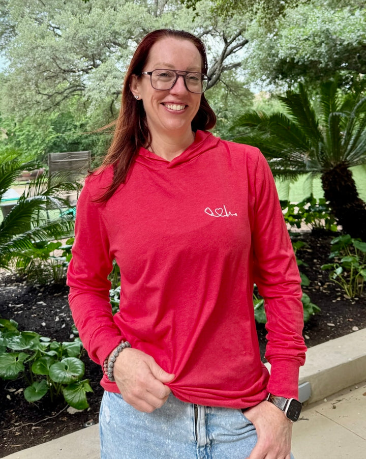 Smiling Dr. Betsy Grunch (Ladyspinedoc) wearing the Dr. Beachgem collab Heart of Medicine Long Sleeve Tee Shirt – Lightweight, Red Hoodie