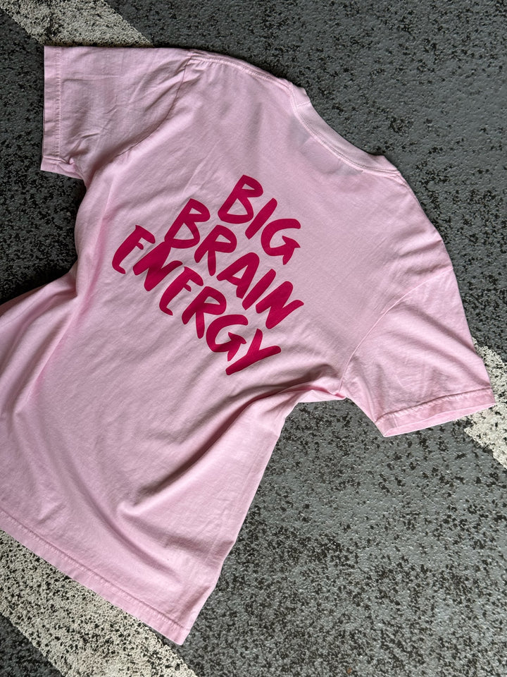 Flat lay of the back of the pink Big Brain Energy t-shirt with bold hot pink text.
