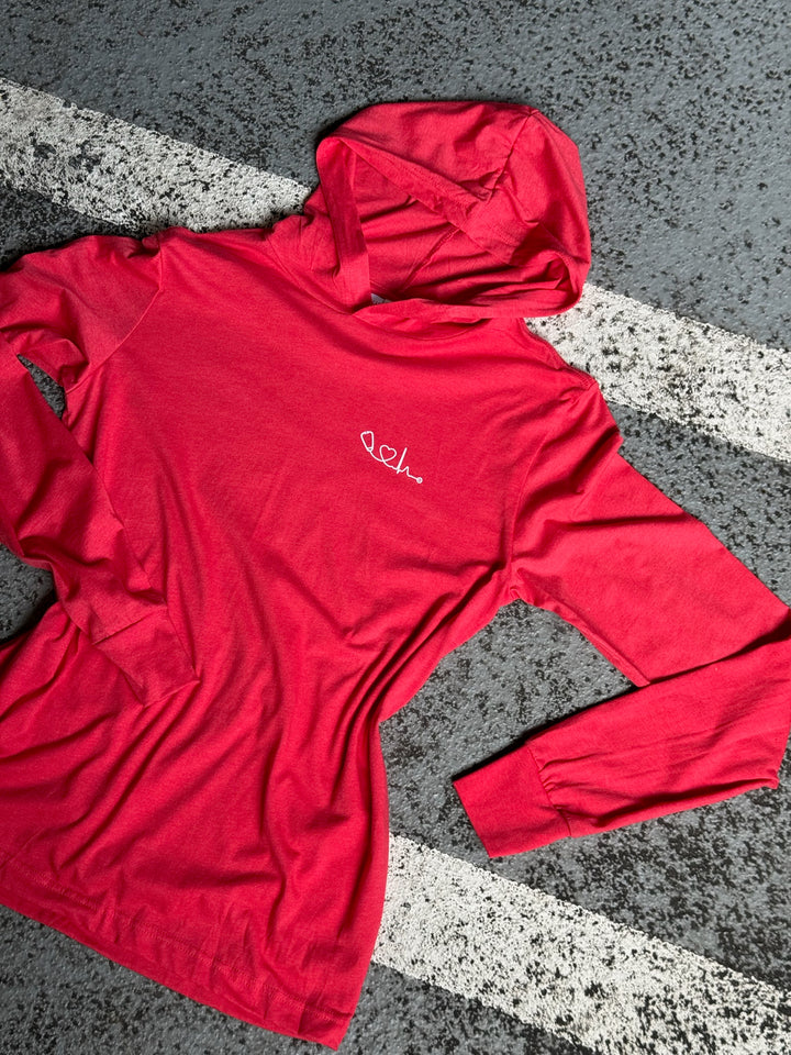 Flat lay of red long sleeve Heart of Medicine hooded t-shirt by Ladyspinedoc x Dr. Beachgem