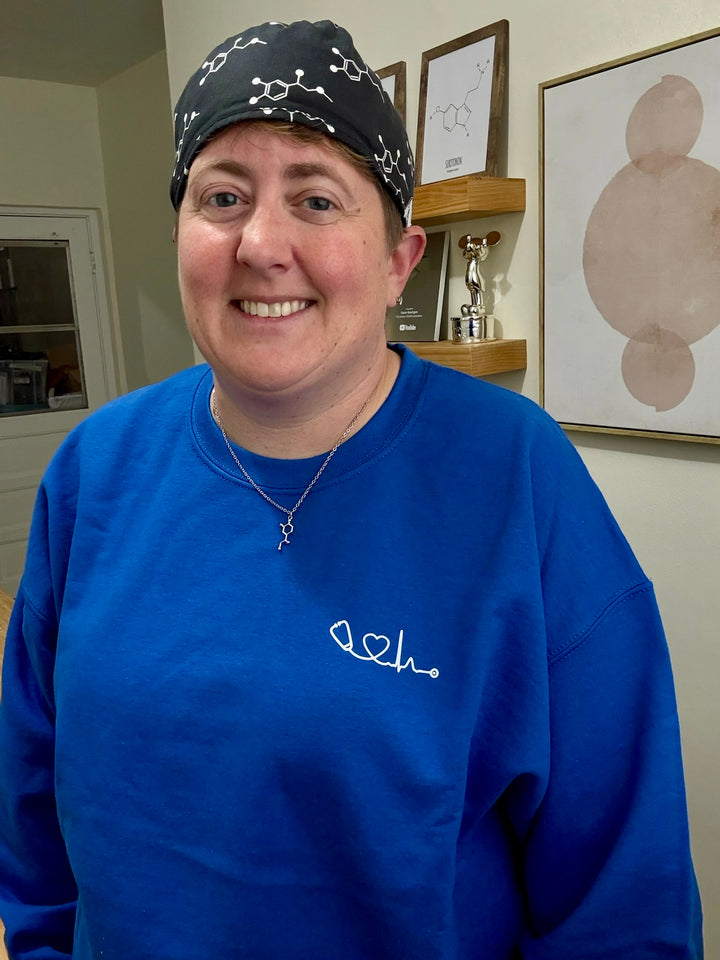 Dr. Beachgem wearing blue Heart of Medicine sweatshirt