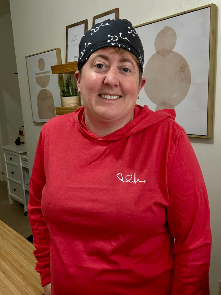 Dr. Beachgem wearing red Heart of Medicine long sleeve hooded tee