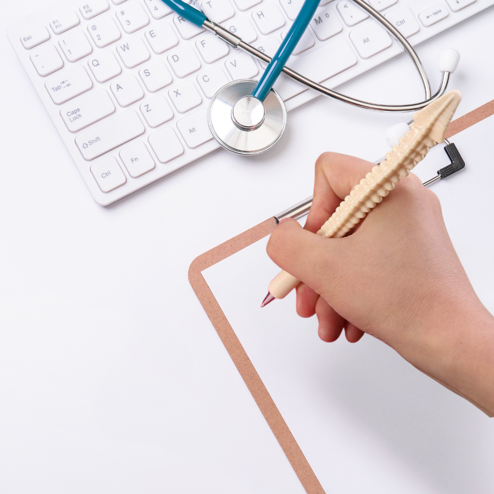 Person holding Spinal Stylus spine pen and getting ready to write on a clipboard.