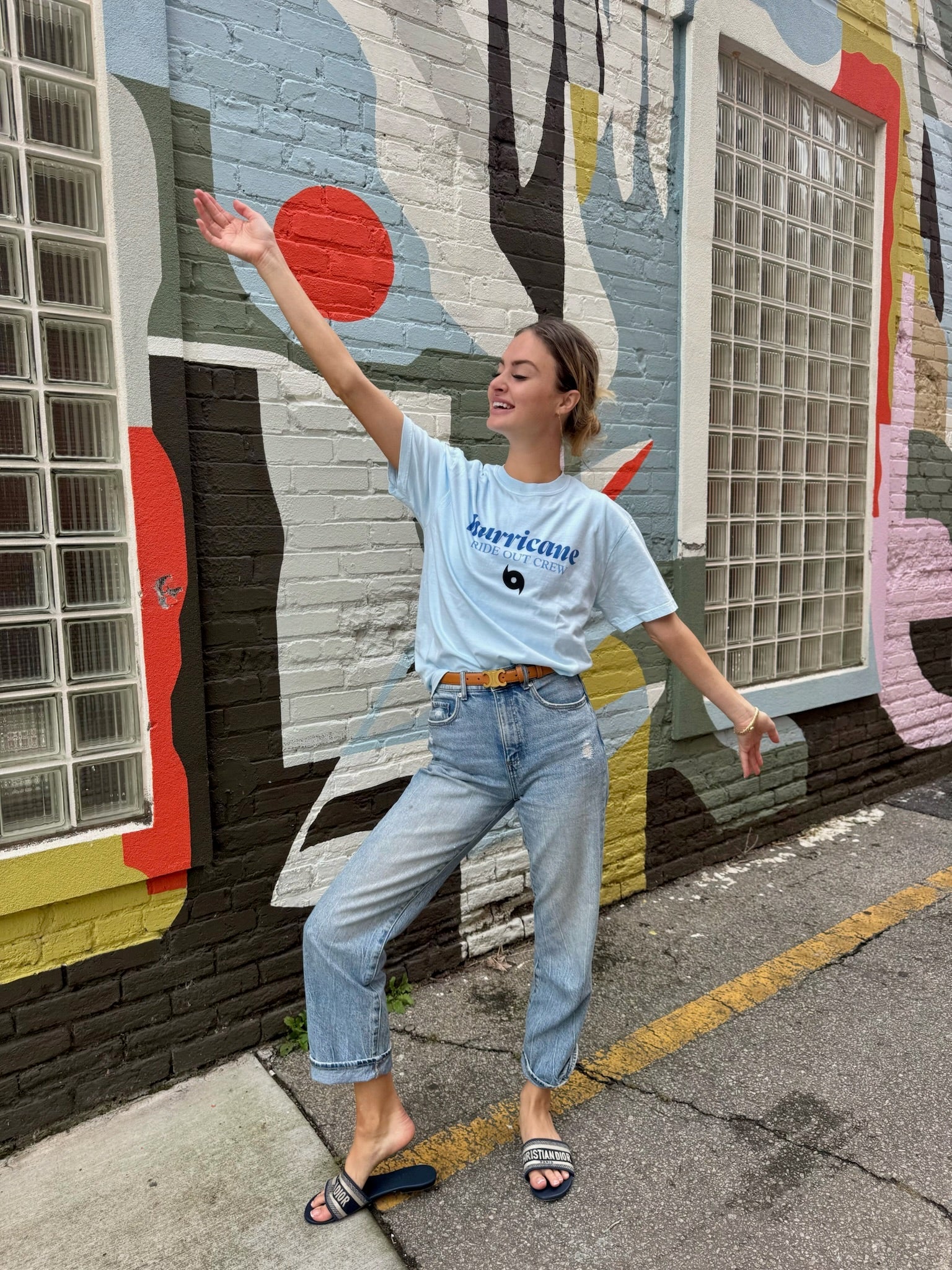 Women modeling a light blue Hurricane Ride Out Crew tee and dark gray "this is why we can't have nice thing" tee