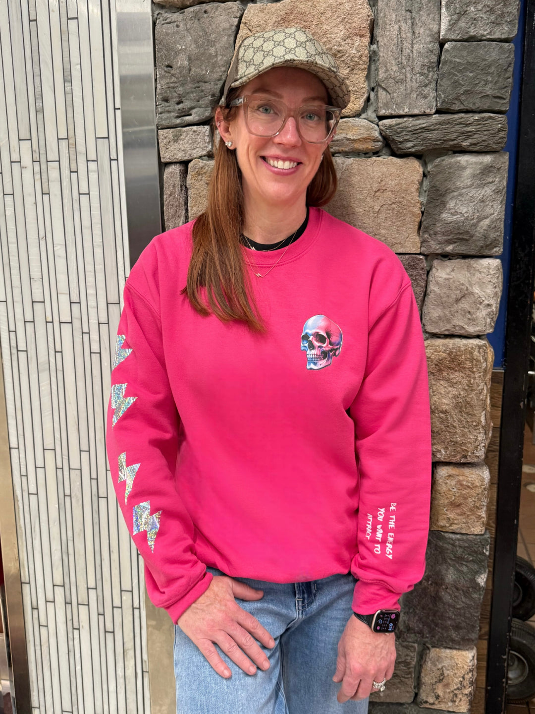 Ladyspinedoc wearing The Power Within Crewneck Sweatshirt - Pink Shirt with Lightning Bolts, Skull, and Motivational "BE THE ENERGY YOU WANT TO ATTRACT" Motto