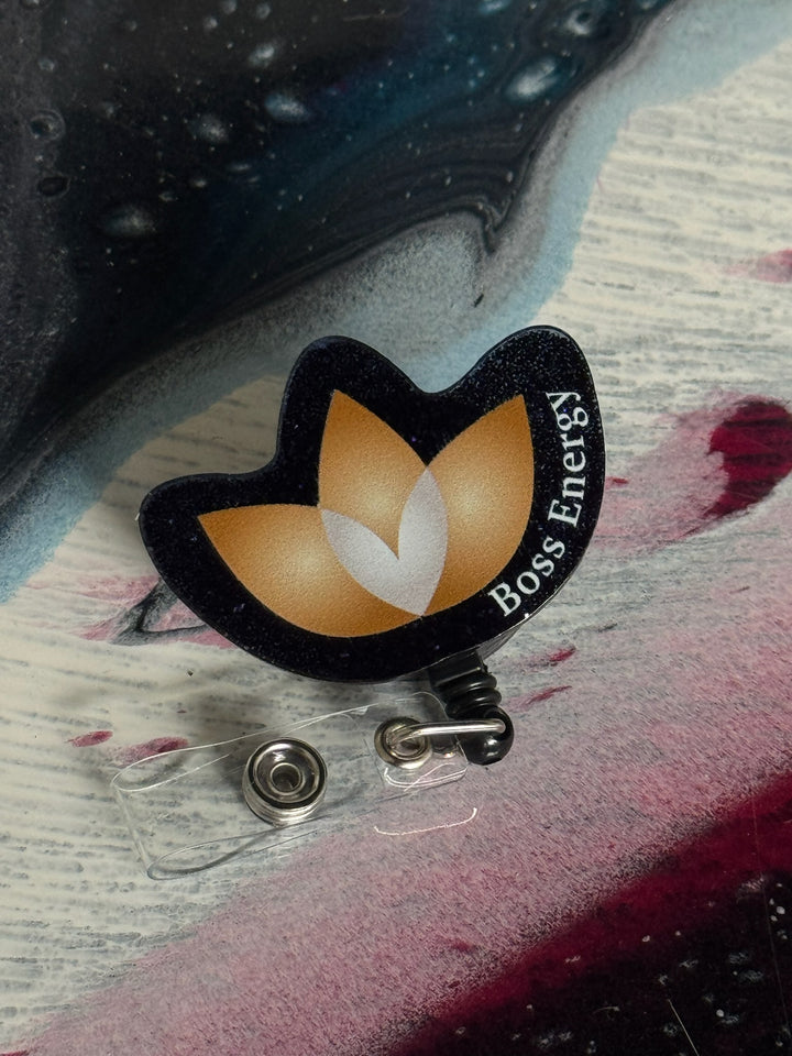 Boss Energy logo badge holder on a colorful surface