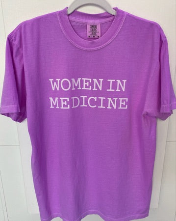 Purple t-shirt with 'WOMEN IN MEDICINE' text on a white background