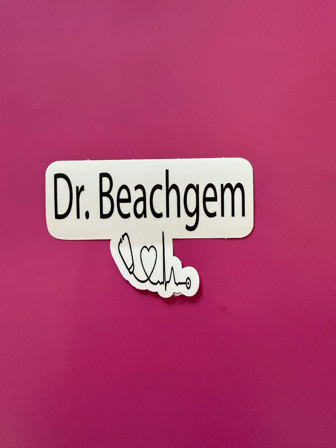 Sticker with 'Dr. Beachgem' text on a pink background