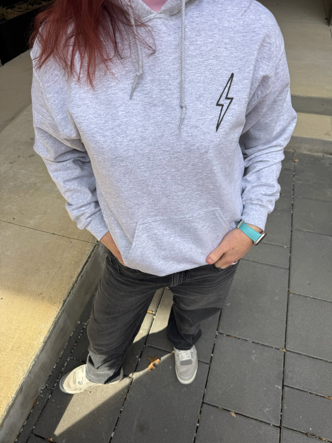 Dr. Betsy Grunch - Ladyspinedoc wearing the BIG BRAIN ENERGY light gray hoodie with the hood up, showcasing the brain design on the left side of the hood.
