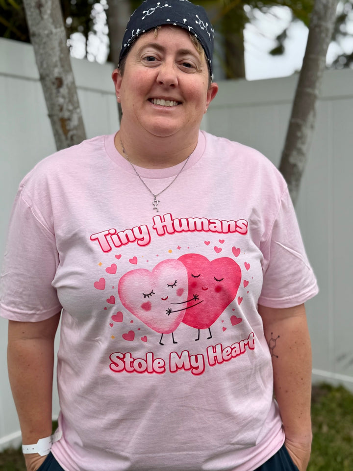 Dr Beachgem wearing a pink t-shirt with heart design and Tiny Humans Stole My Heart text outdoors