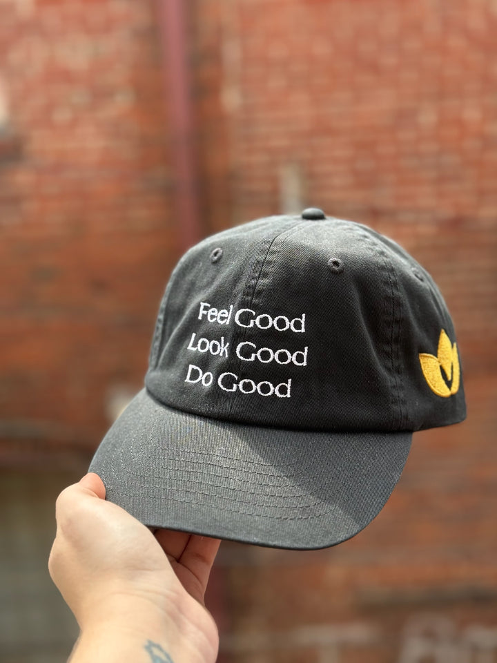 Feel Good, Look Good, Do Good black cotton ball cap showing embroidered motto on front and golden Confidence Doc logo on the side