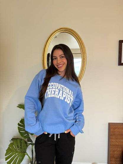 OT Sophie Perez wearing the blue Occupational Therapist sweatshirt designed by Ladyspinedoc (Dr. Betsy Grunch)