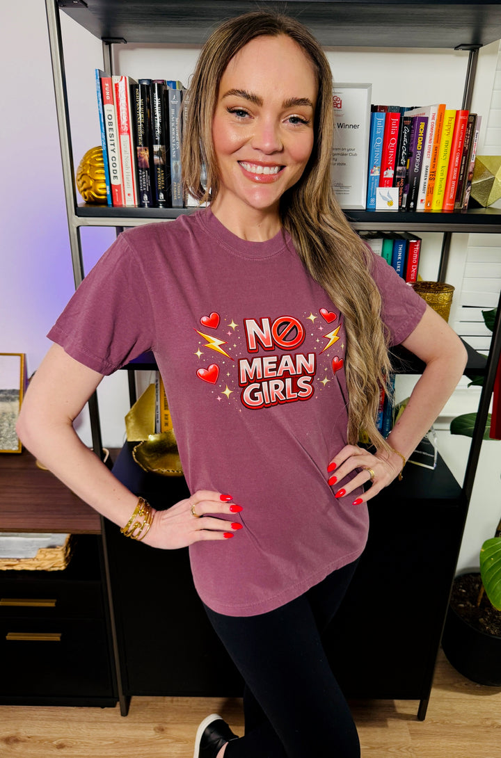 Dr. Brain Barbie wearing a burgundy No Mean Girls Tee in front of a bookcase