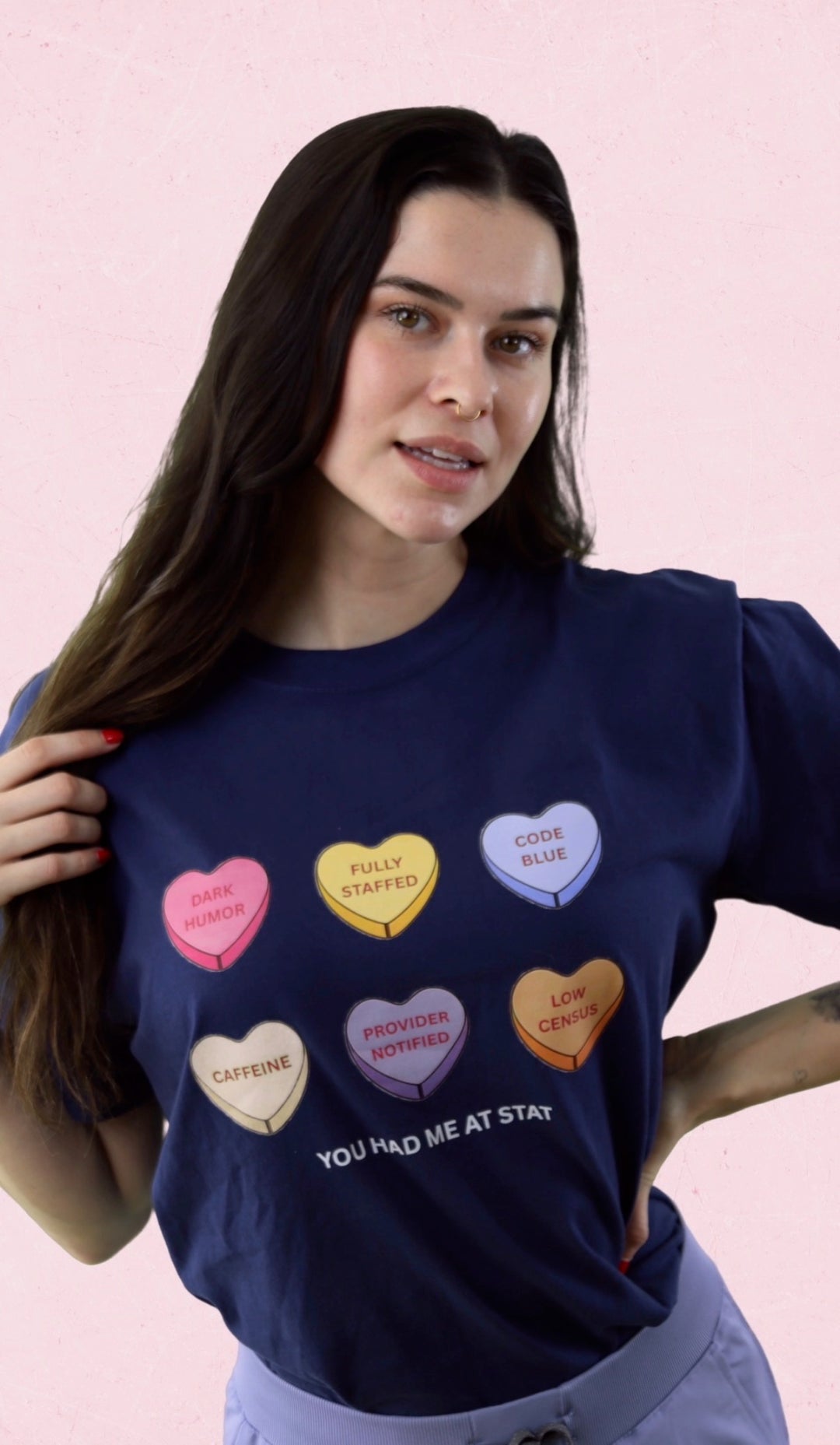 Scrubhacks wearing Navy Nurse Tee with colorful Candy Hearts and You Had Me At Stat motto.