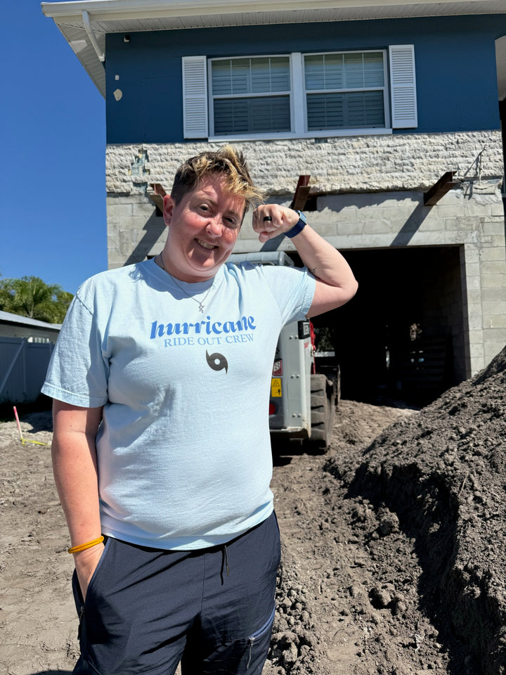 Dr. Beachgem wearing a blue 'Hurricane Ride Out Crew t-shirt in front of her house under construction
