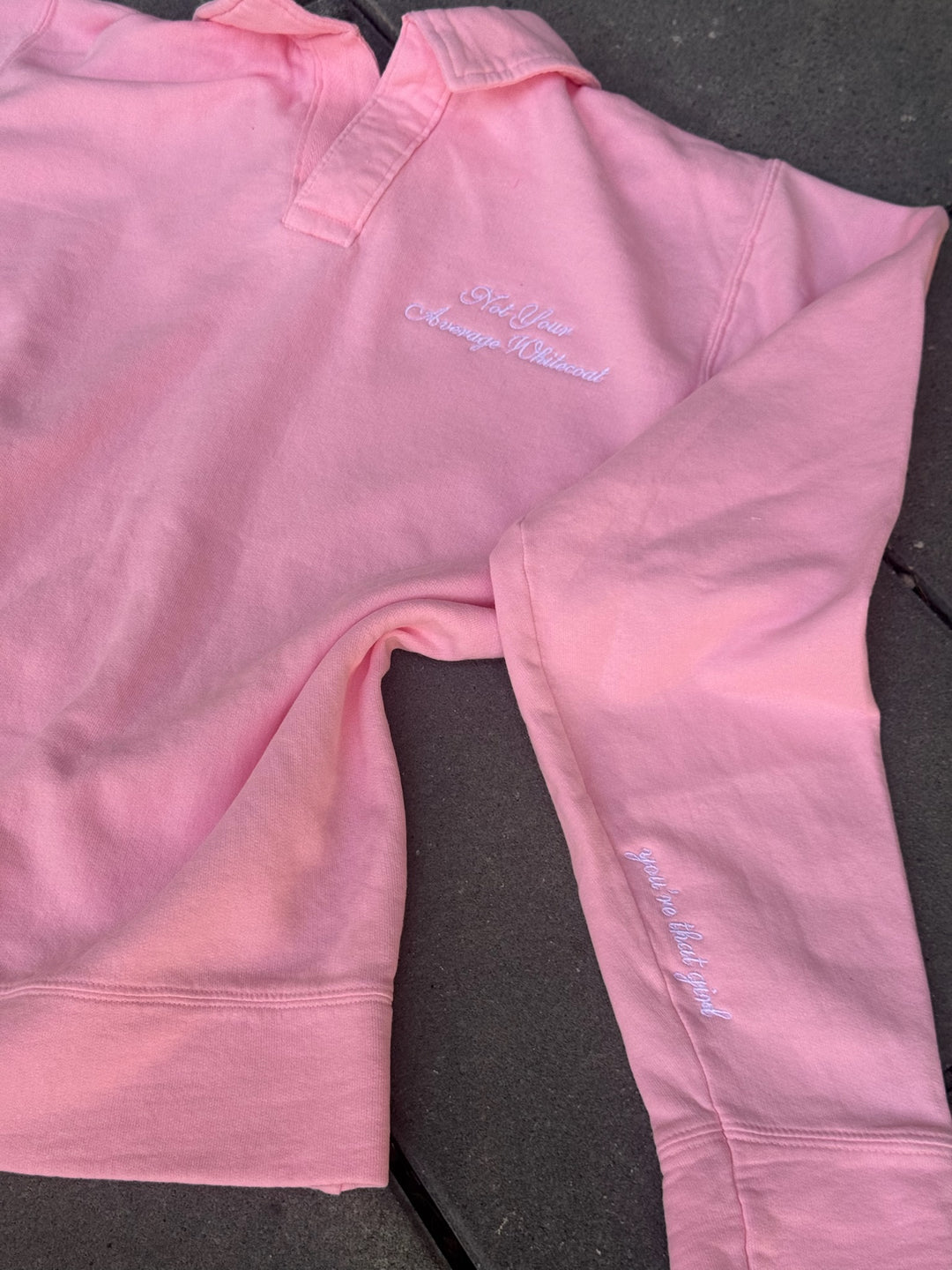 Flat lay of Ladyspinedoc x Dr. Daisy Collab: Embroidered 'Not Your Average Whitecoat' - Pink Polo Collar Sweatshirt