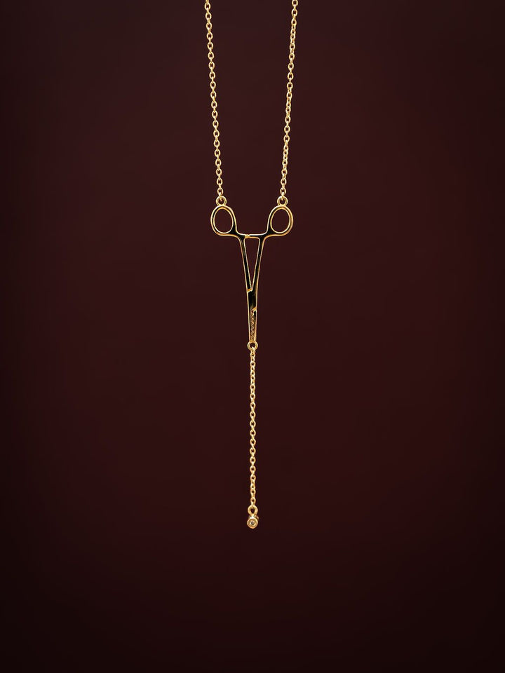 Close-up of gold Erin Necklace: Hemostat With Diamond Drop