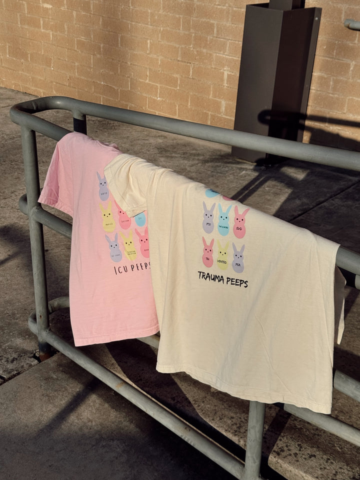 The  Trauma Squad and ICU Squad tee shirts displayed on a metal railing. 