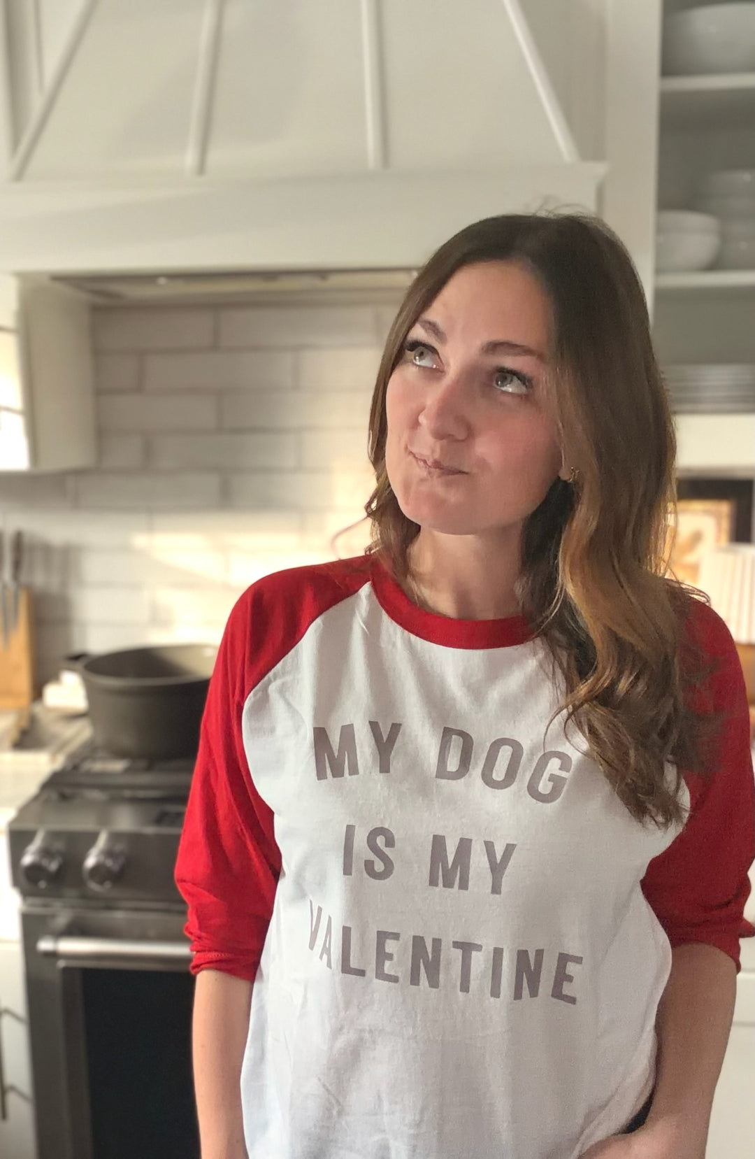 Dr Molly wearing a shirt with 'My dog is my valentine' text in a kitchen.