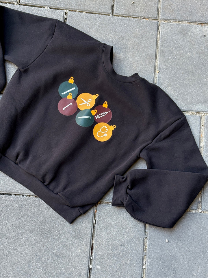 Black cropped surgical ornament sweatshirt on pavement